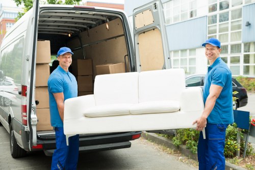 Man with a van loading furniture in a Fulham street