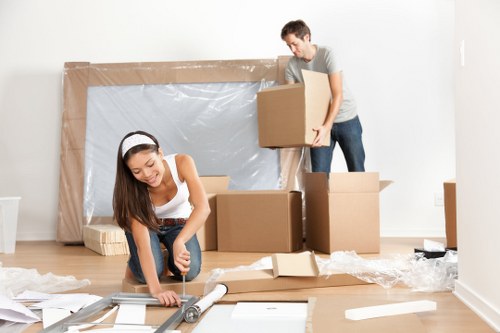 Professional movers transporting office equipment through Fulham