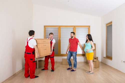 Van removal service moving boxes and furniture on a Fulham street