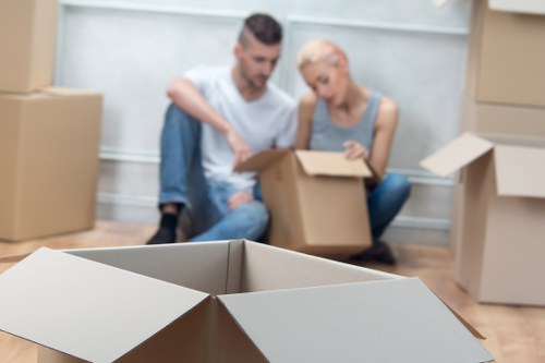 Professional mover carrying items through a Fulham property