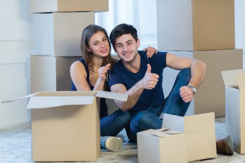 Moving boxes and furniture inside a Fulham flat with stair access