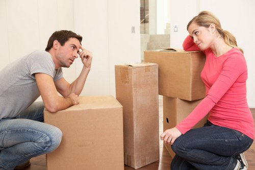 Removal workers loading items from a Fulham flat with stair access